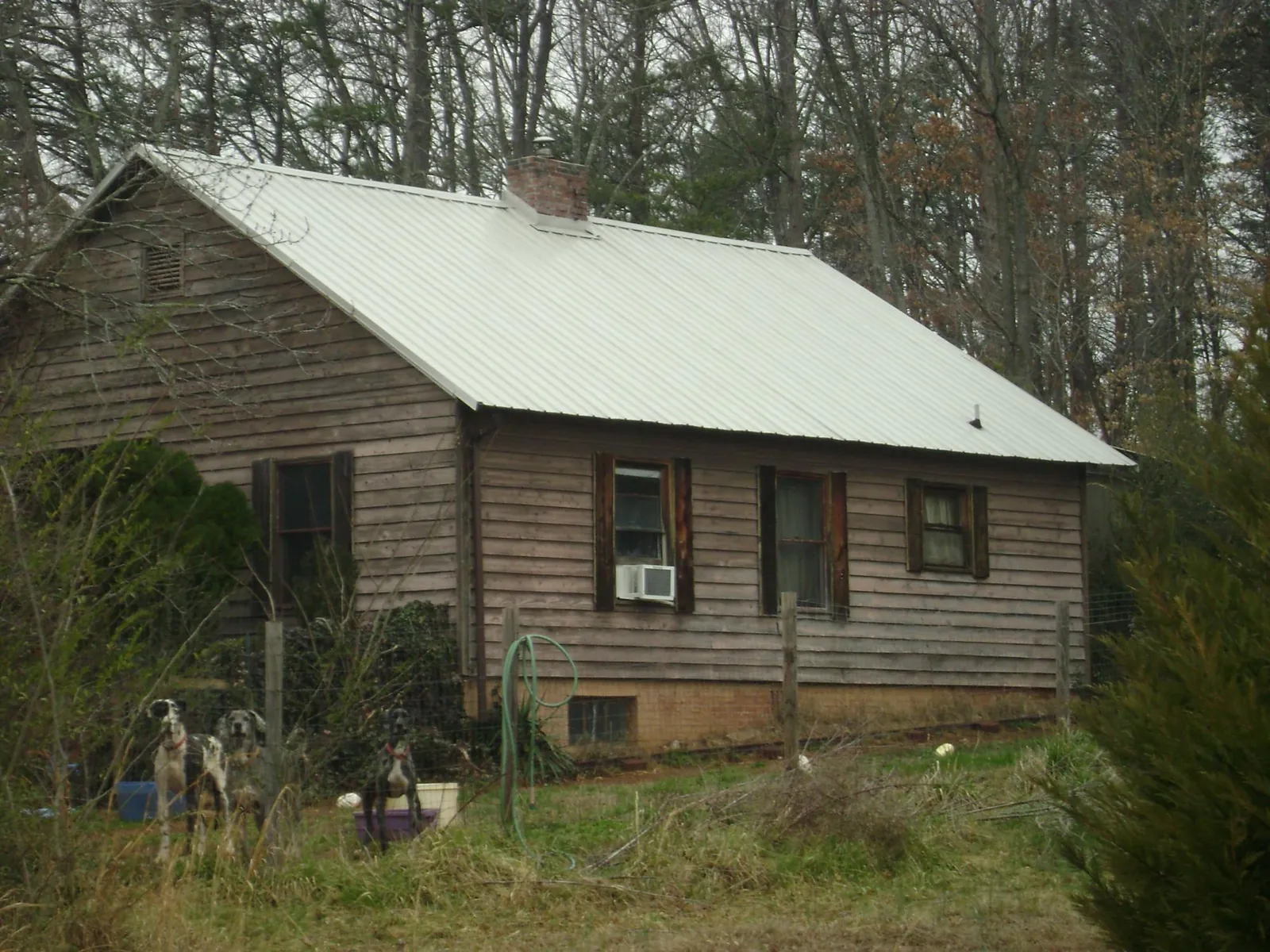 White metal roof on an old wood sided farmhouse, from a Metal Roof Installation job in Pilger